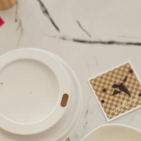 Coffee served with a Cafe K Streets checkerboard card